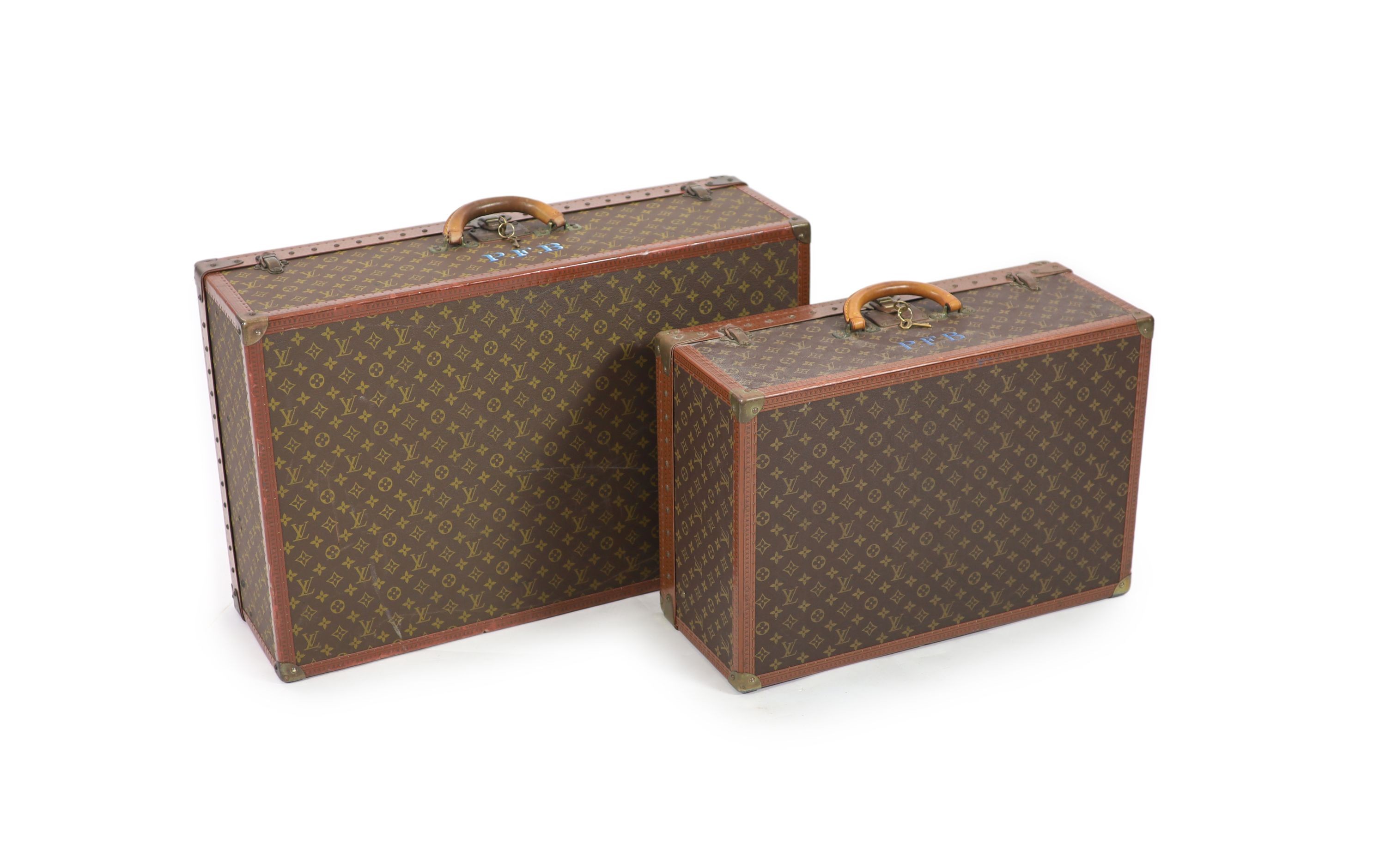 Two graduated Louis Vuitton Alzer suitcase trunks